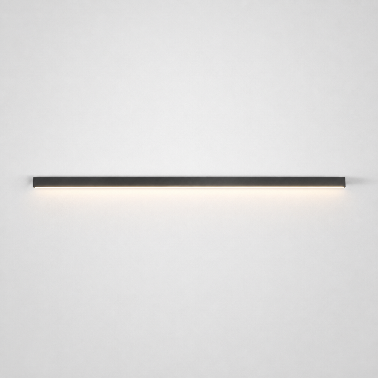 Slim black wall light mounted horizontally on a neutral wall with a soft downward glow.