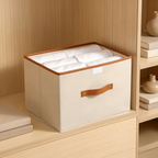 Foldable storage box open with neatly folded white textiles.