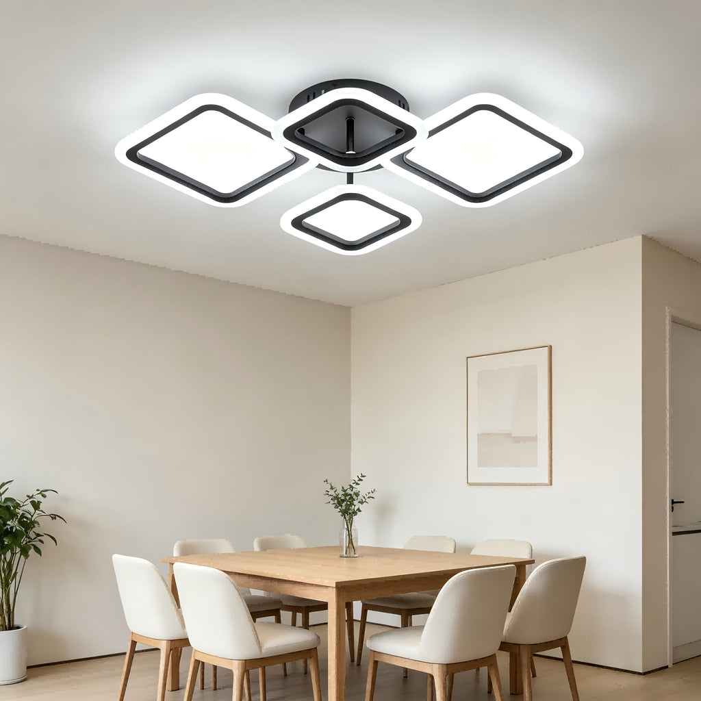 Black four frame LED light above a dining space