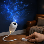 Galaxy projector casting blue stars while its inline brightness control is pressed