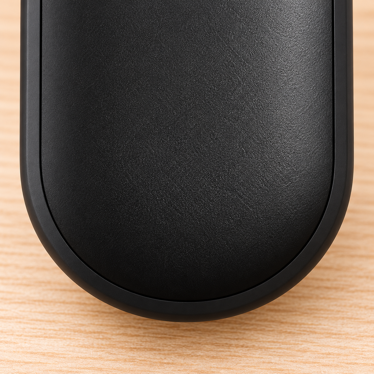 Detail of the rounded lower housing and textured surface of a black hand warmer