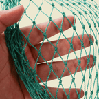 Close view of green two strand garden netting held against a hand
