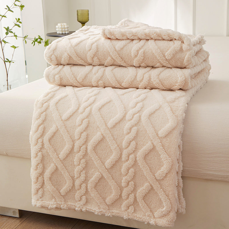 Beige geometric fleece blanket folded over a seat