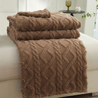 Coffee brown patterned fleece throw folded on a seat