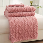 Pink raised pattern fleece blanket folded on a seat