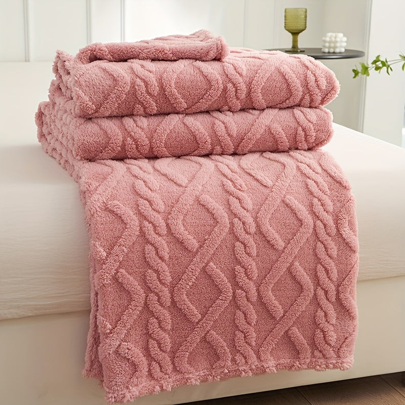 Pink raised pattern fleece blanket folded on a seat