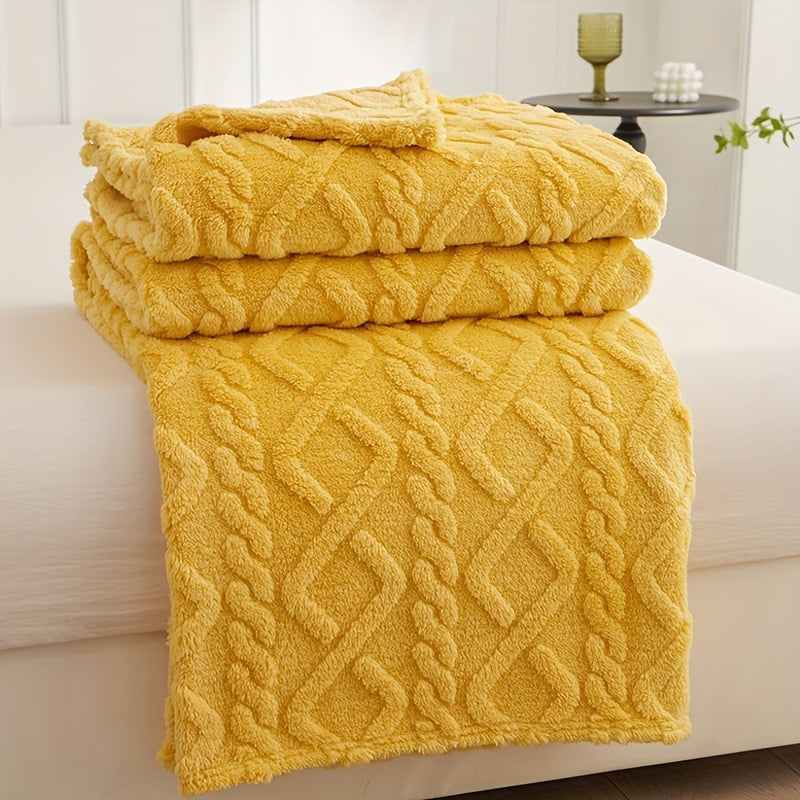 Yellow geometric fleece throw folded on a seat