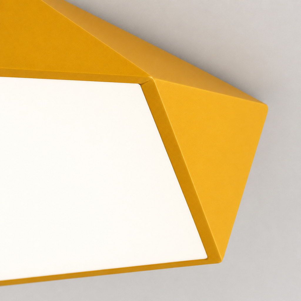 Close-up of the geometric LED ceiling light showing painted iron edges and a faceted form.