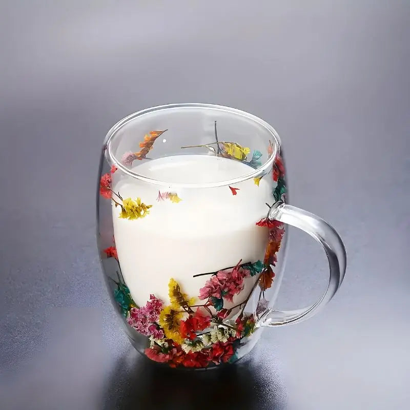 Floral double wall glass mug filled with a white beverage