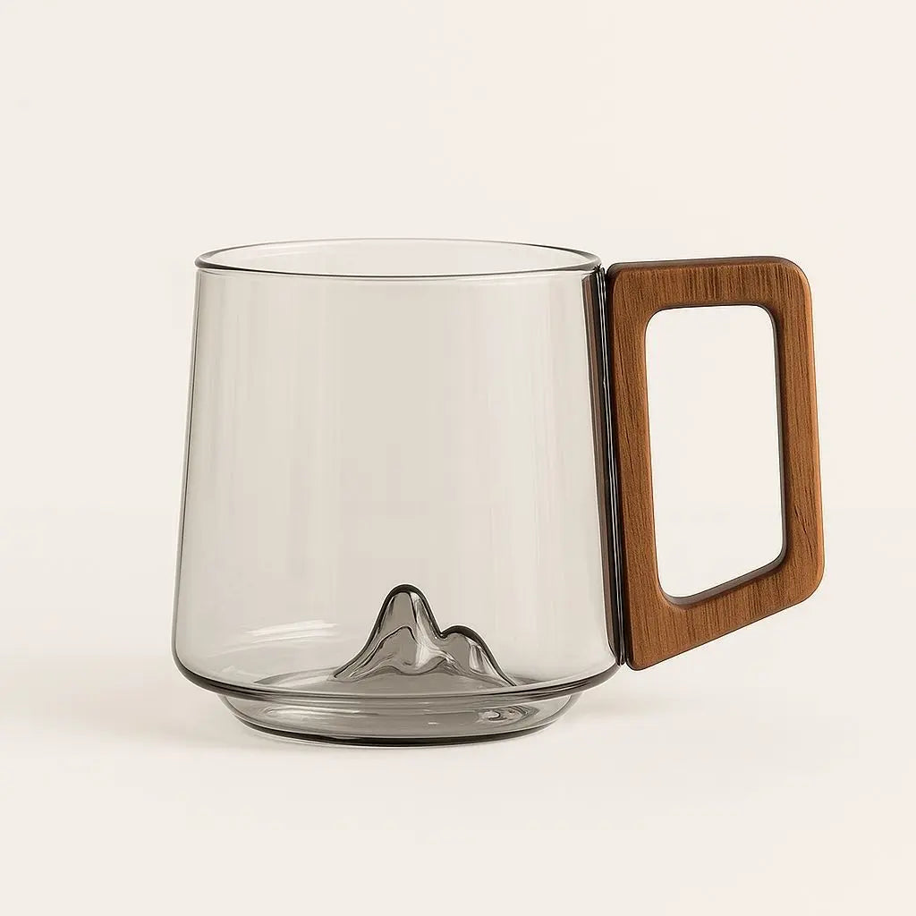 Empty smoky glass mug with sculpted mountain base and wooden handle