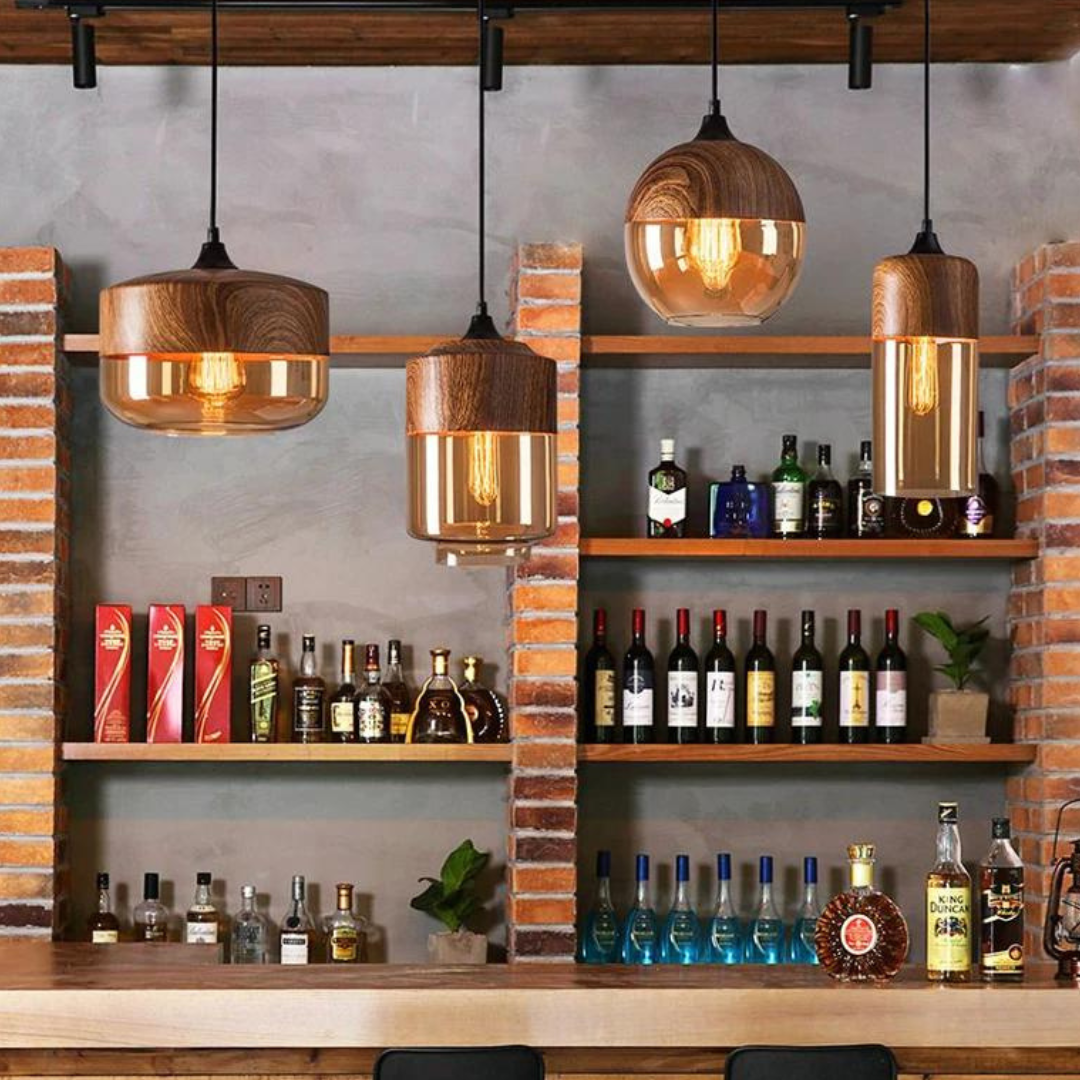 Glass pendant light styles above a bar with bottles on shelves