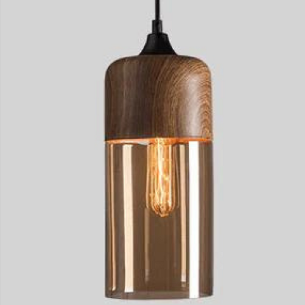 Tall cylindrical glass pendant light with a wood look upper shade