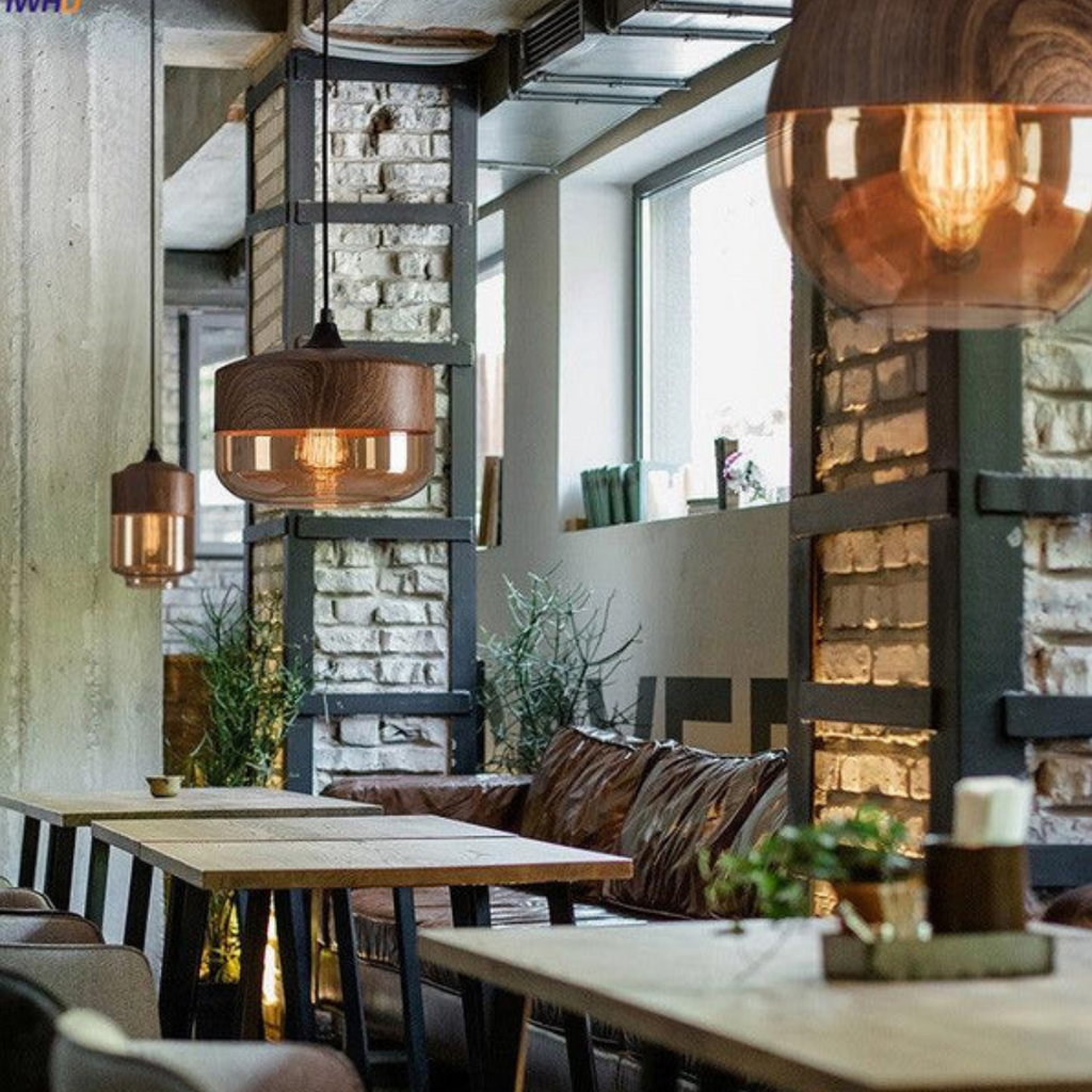 Glass pendant light arrangement above seating near tall windows