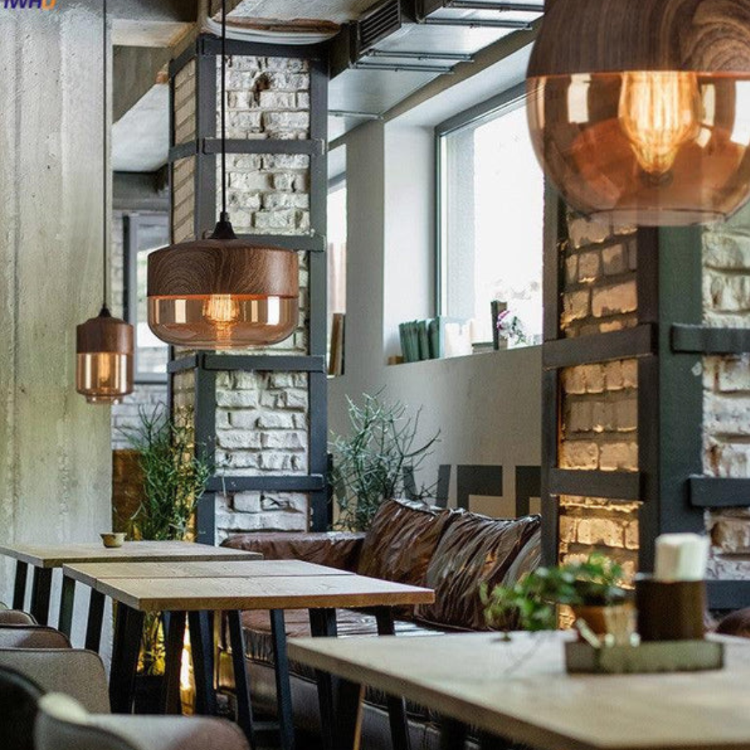 Glass pendant light arrangement above seating near tall windows