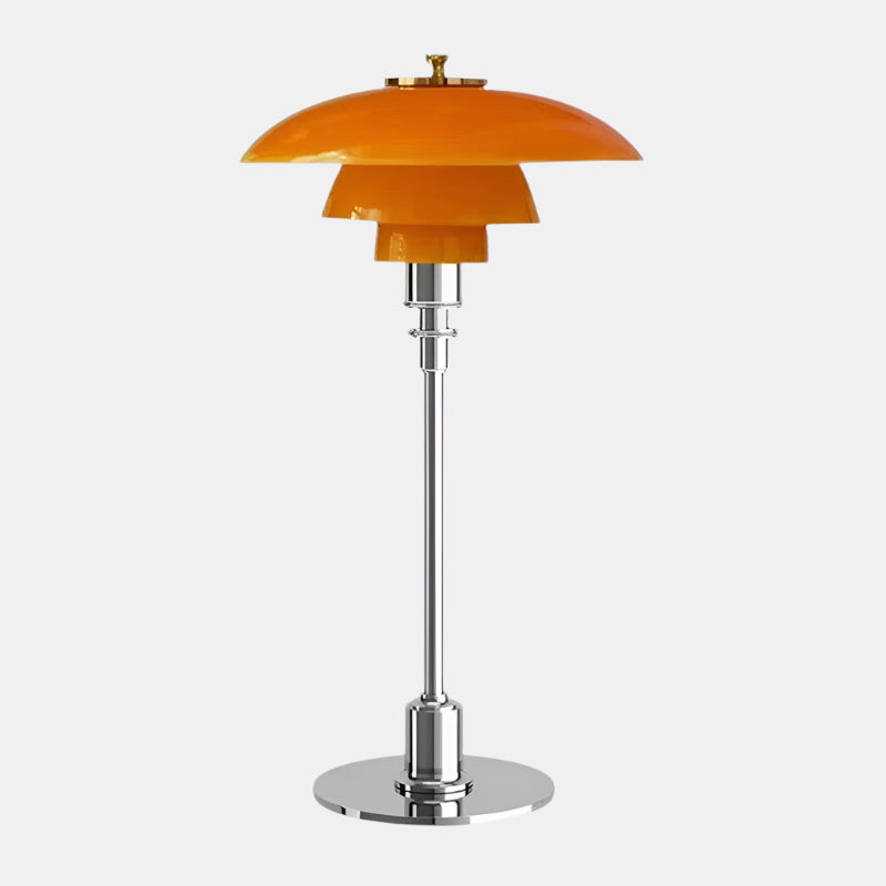 Amber glass table lamp with a silver finish base on a plain background