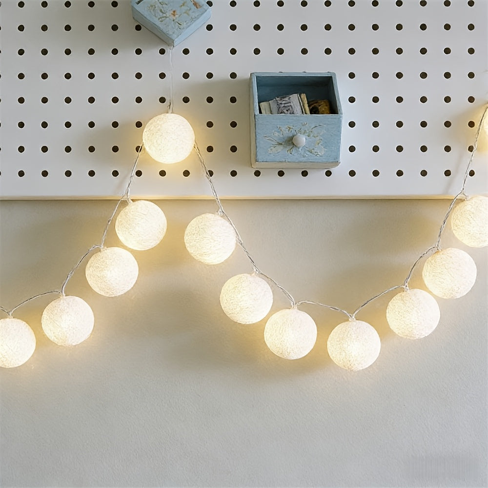 Globe fairy lights hanging across a white pegboard.