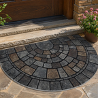 Half circle mosaic door mat shown on a sunlit stone front porch.