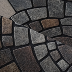 Close view of the textured fibers and stone pattern on a mosaic door mat.