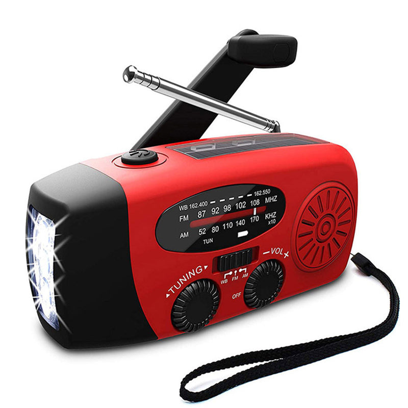 Red and black AM FM radio with hand crank, antenna, LED flashlight, and strap