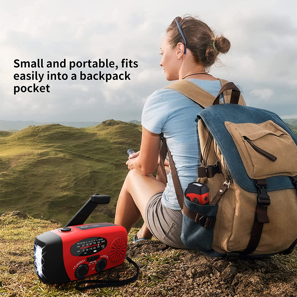 Red hand crank radio pictured beside a hiker wearing a backpack