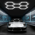Hexagon LED garage light with five connected grids above a silver car.