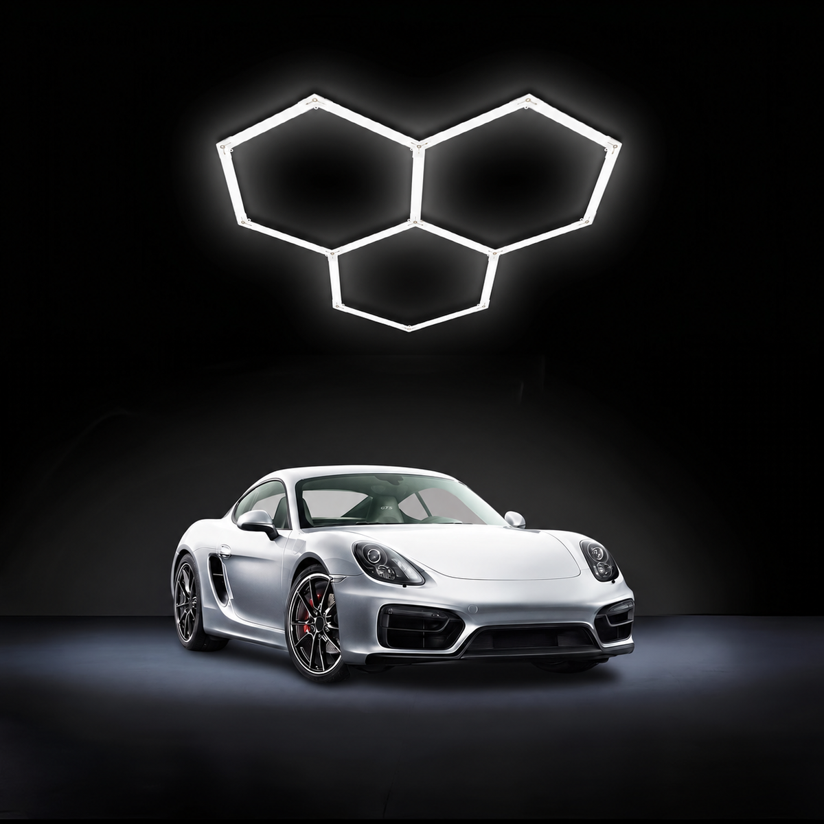 Hexagon LED garage light with three connected grids above a silver car.
