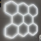 Hexagon LED garage light with eight connected grids mounted on a plain ceiling.
