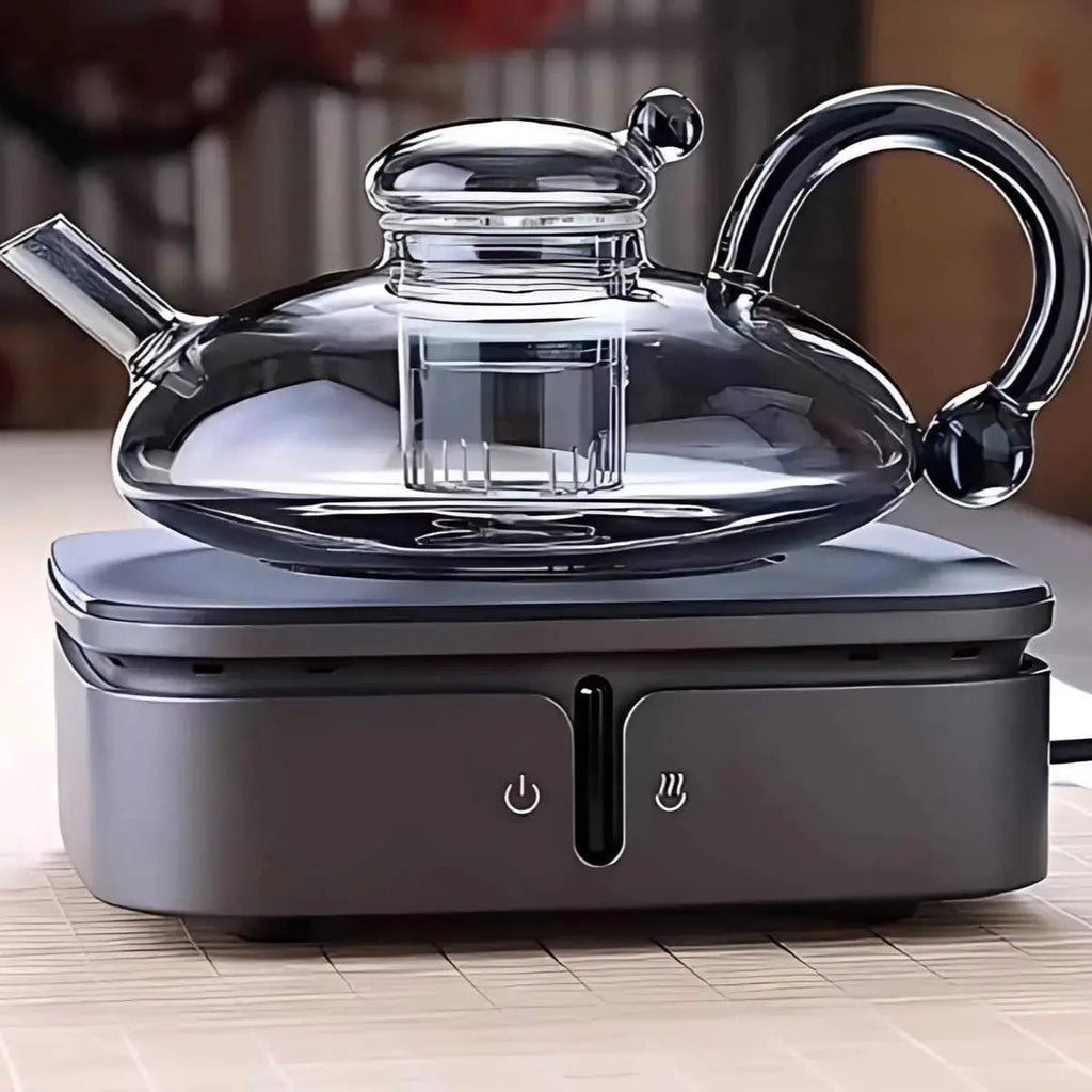 Ceramic hot plate shown heating a teapot on a tabletop