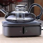 Ceramic hot plate shown heating a teapot on a tabletop