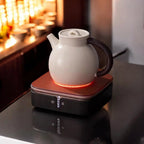 Ceramic hot plate shown heating a teapot on a tabletop