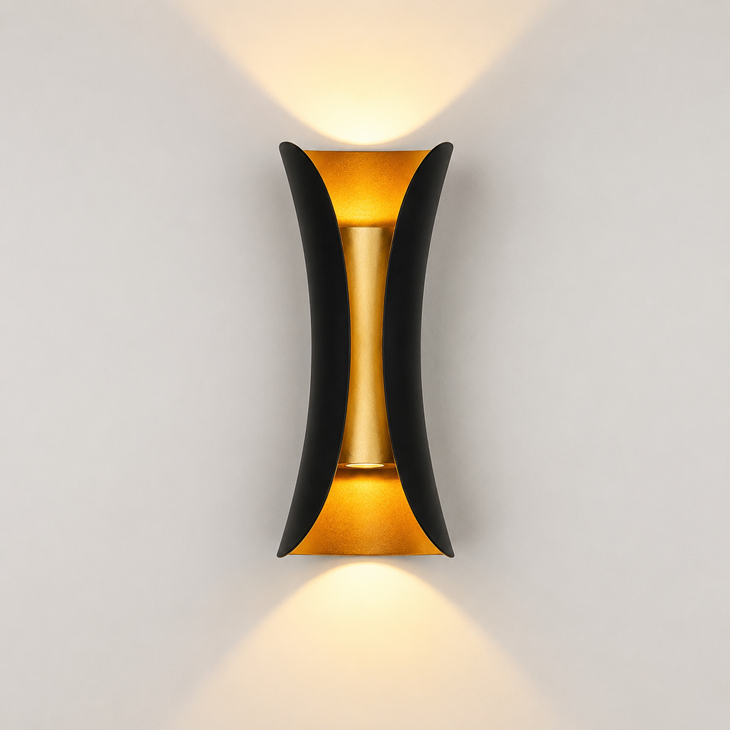 Black and gold outdoor wall sconce mounted on a light wall, casting warm light upward and downward.