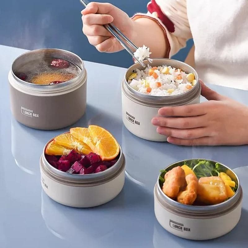 Insulated lunch box shown as open brown, white, and blue containers filled with food.