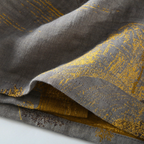 Gray cotton kimono bathrobe fabric showing its yellow woven pattern.