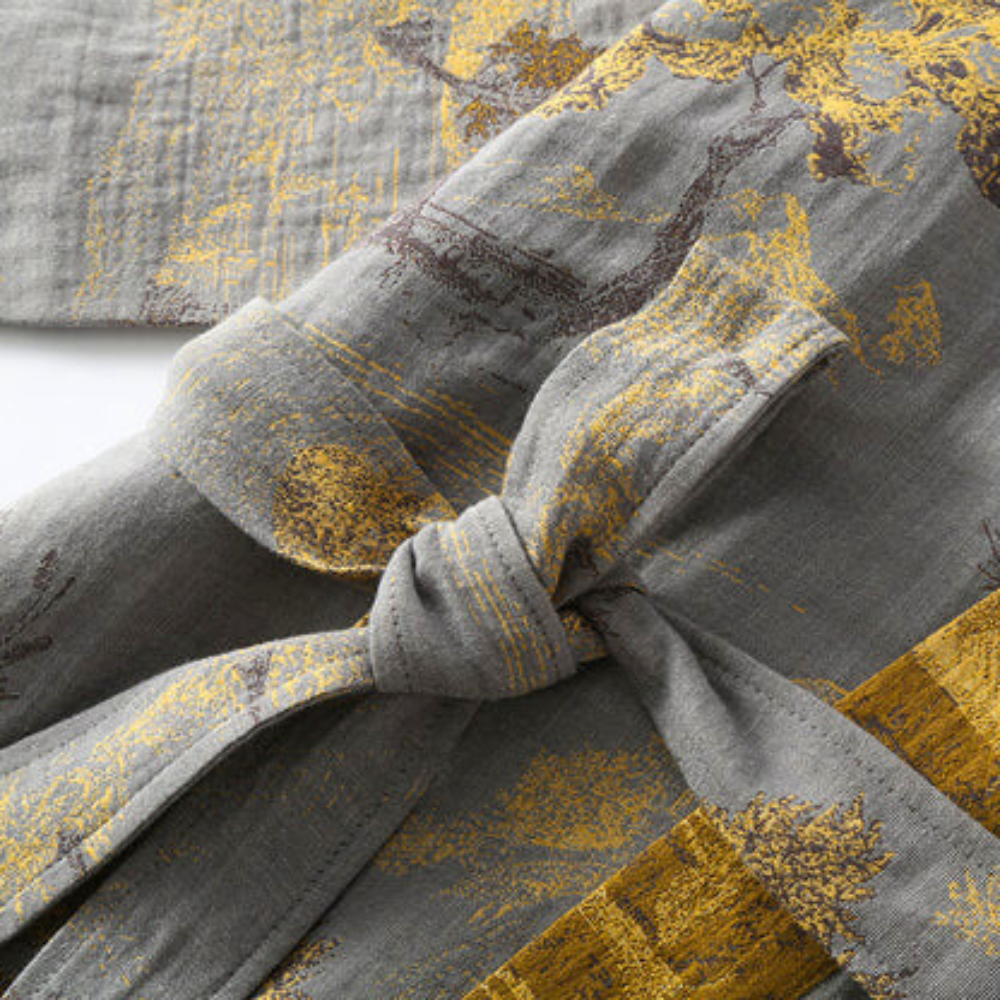 Gray kimono bathrobe showing the tie belt against patterned cotton fabric.