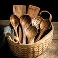 Teak kitchen utensil set arranged with wooden cooking tools.