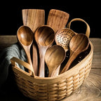 Teak kitchen utensil set arranged with wooden cooking tools.