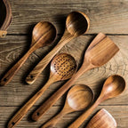 Natural brown teak utensil set with spoons and spatulas.
