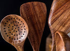 Close view of handcrafted teak kitchen utensils.