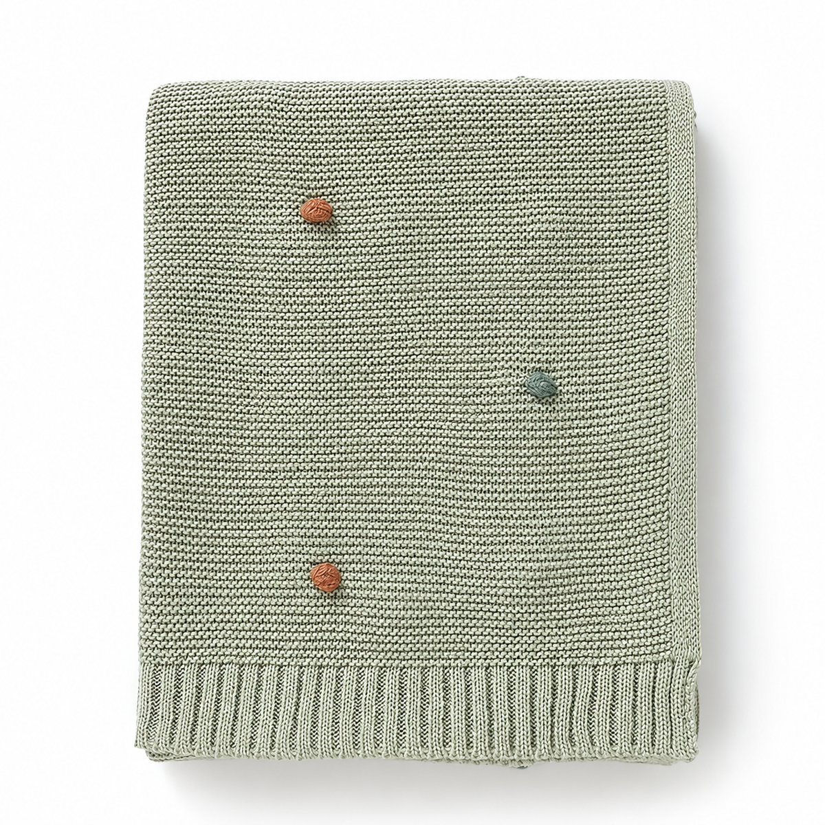 Light green acrylic knit throw blanket showing colored dots and ribbed borders