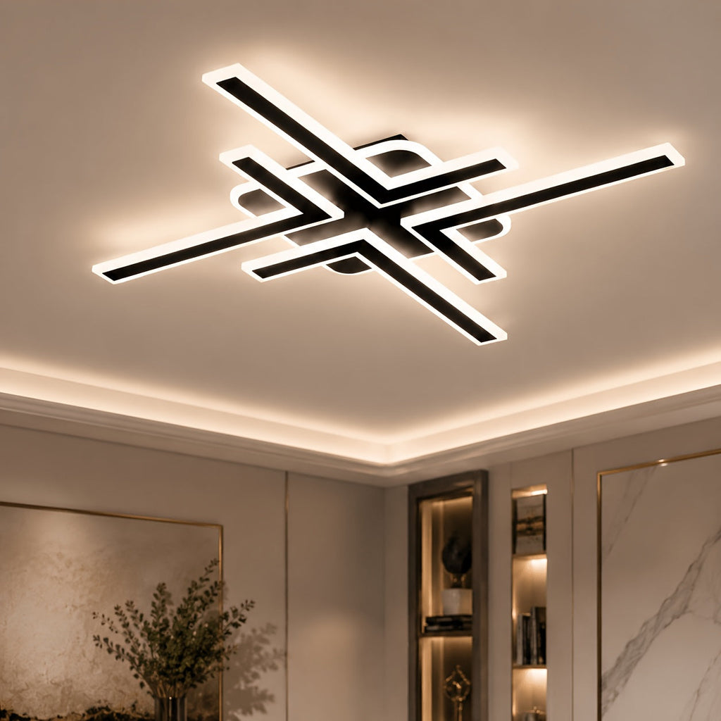 Black geometric cross line LED ceiling light glowing against a ceiling.