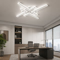White geometric cross line LED ceiling light above a modern desk.