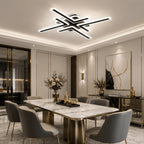 Black geometric cross line LED ceiling light above a dining table.