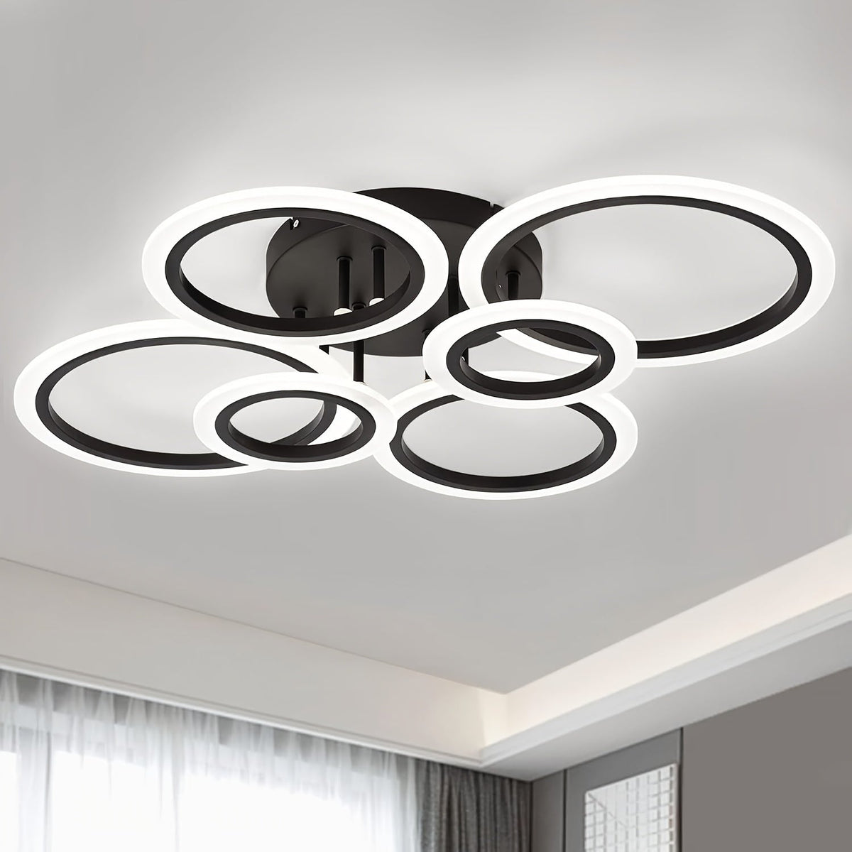 Black six ring LED ceiling light with white illuminated acrylic diffusers.