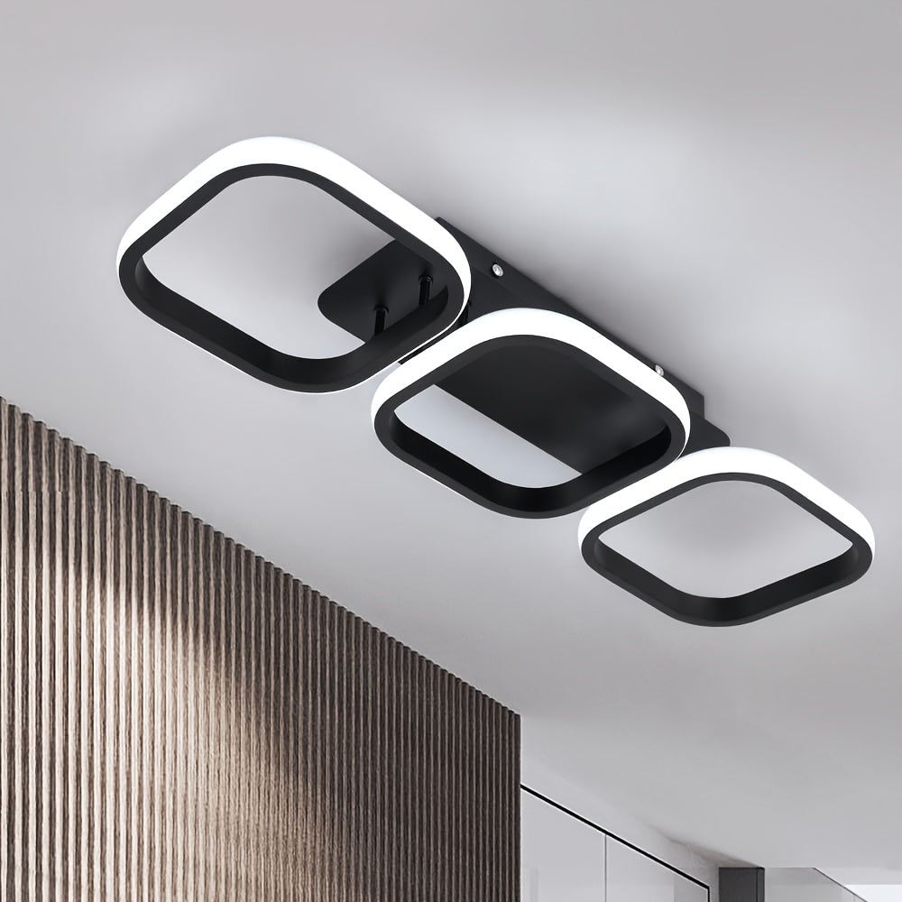 Black three frame LED ceiling light installed close to a white ceiling.