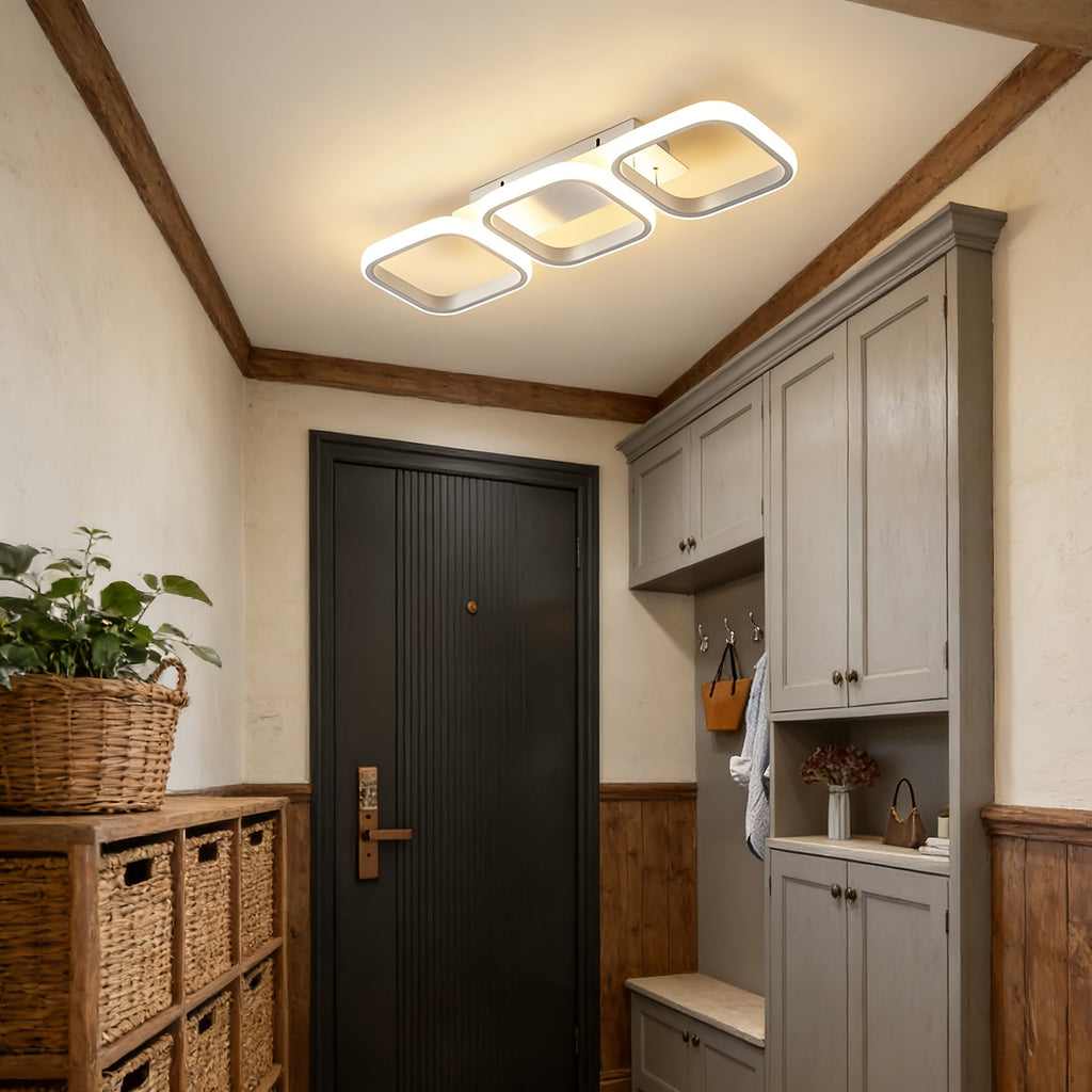White three frame LED ceiling light above an entryway and kitchen area.