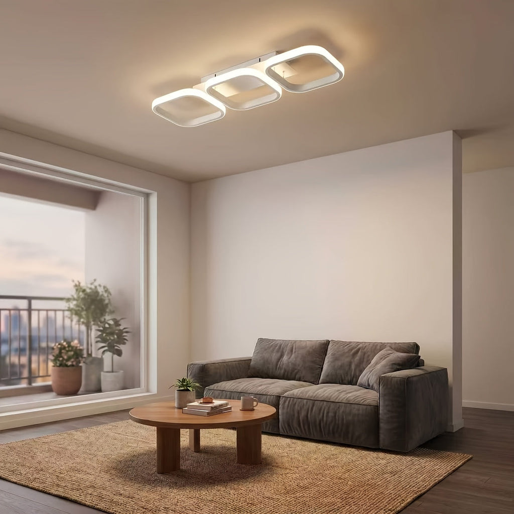 White three frame LED ceiling light above a furnished living room.