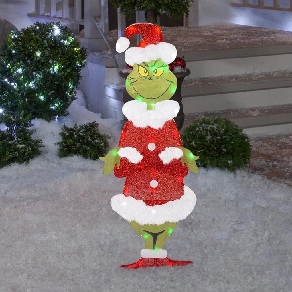 LED Grinch garden decoration glowing as a colorful outdoor Christmas accent.