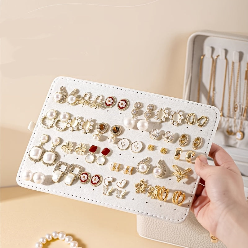 Removable earring panel held above the open jewelry box
