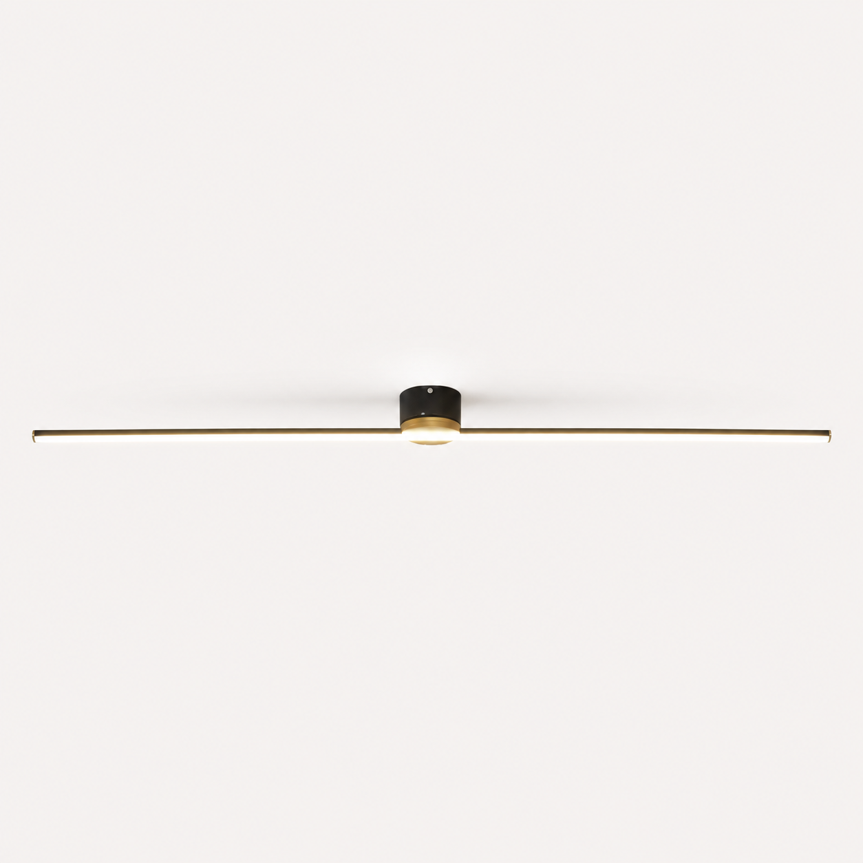 Black linear flush mount ceiling light glowing against a plain off-white background.