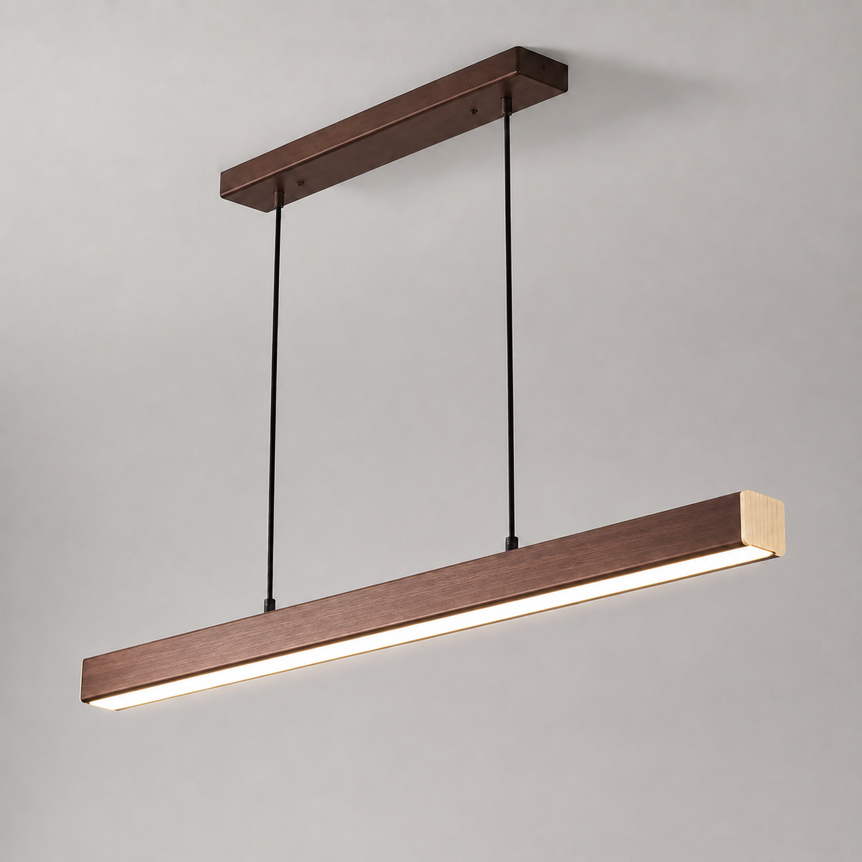 Wood-tone linear pendant light suspended from a matching canopy and glowing on a light gray background.